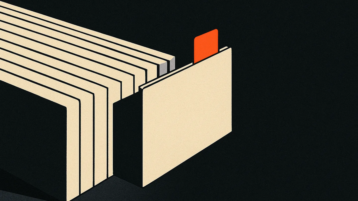 A row of index cards split into two groups on a dark desk, one card marked with an ember-orange tab.