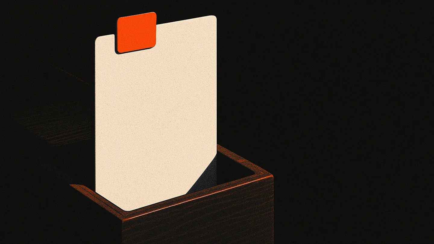 A single card standing upright in a dark card file, one ember-orange tab marking it.