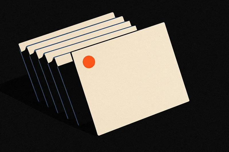 A fan of blank index cards on black, one card marked with a small ember dot standing apart from the rest.