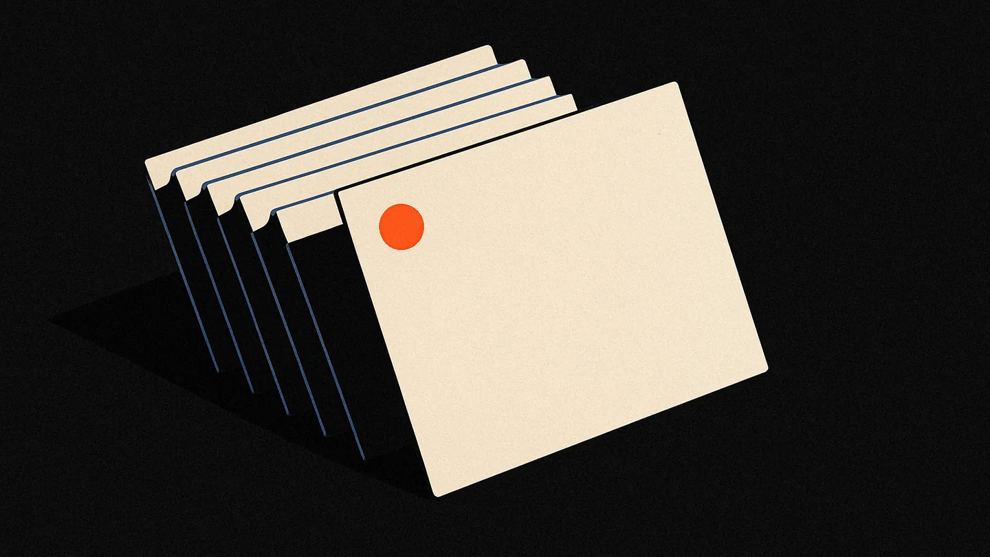 A fan of blank index cards on black, one card marked with a small ember dot standing apart from the rest.