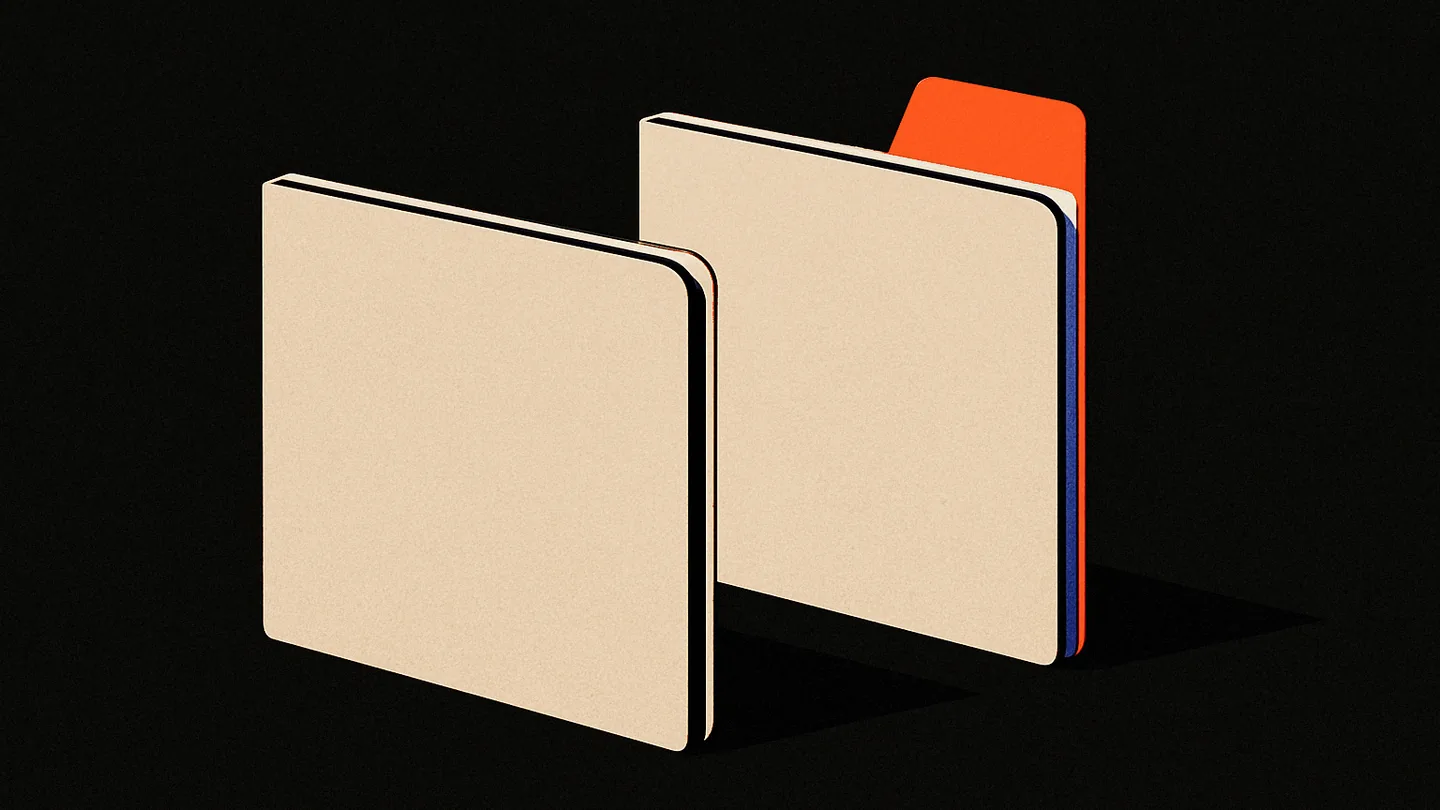 Two identical bone-colored folders on a black desk, one with a single orange tab standing up from its spine, the other flat and untouched.