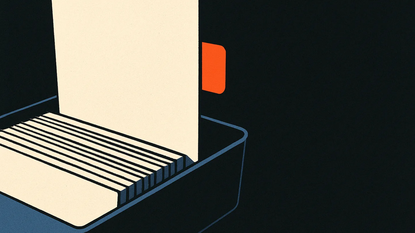 A single index card standing upright in a tray of blank cards, one ember tab marking it apart from the rest.
