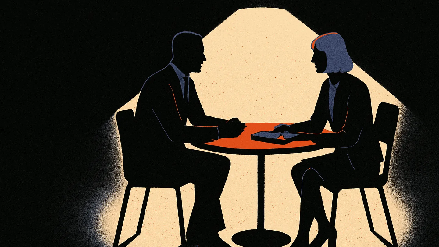 Two silhouetted figures at a small round table lit in a dark room, an ember-orange dot glowing on a notebook between them.