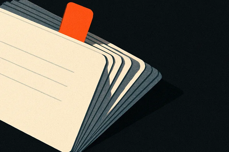A fanned stack of index cards on black, one card pulled forward with a small ember-orange tab marking it.